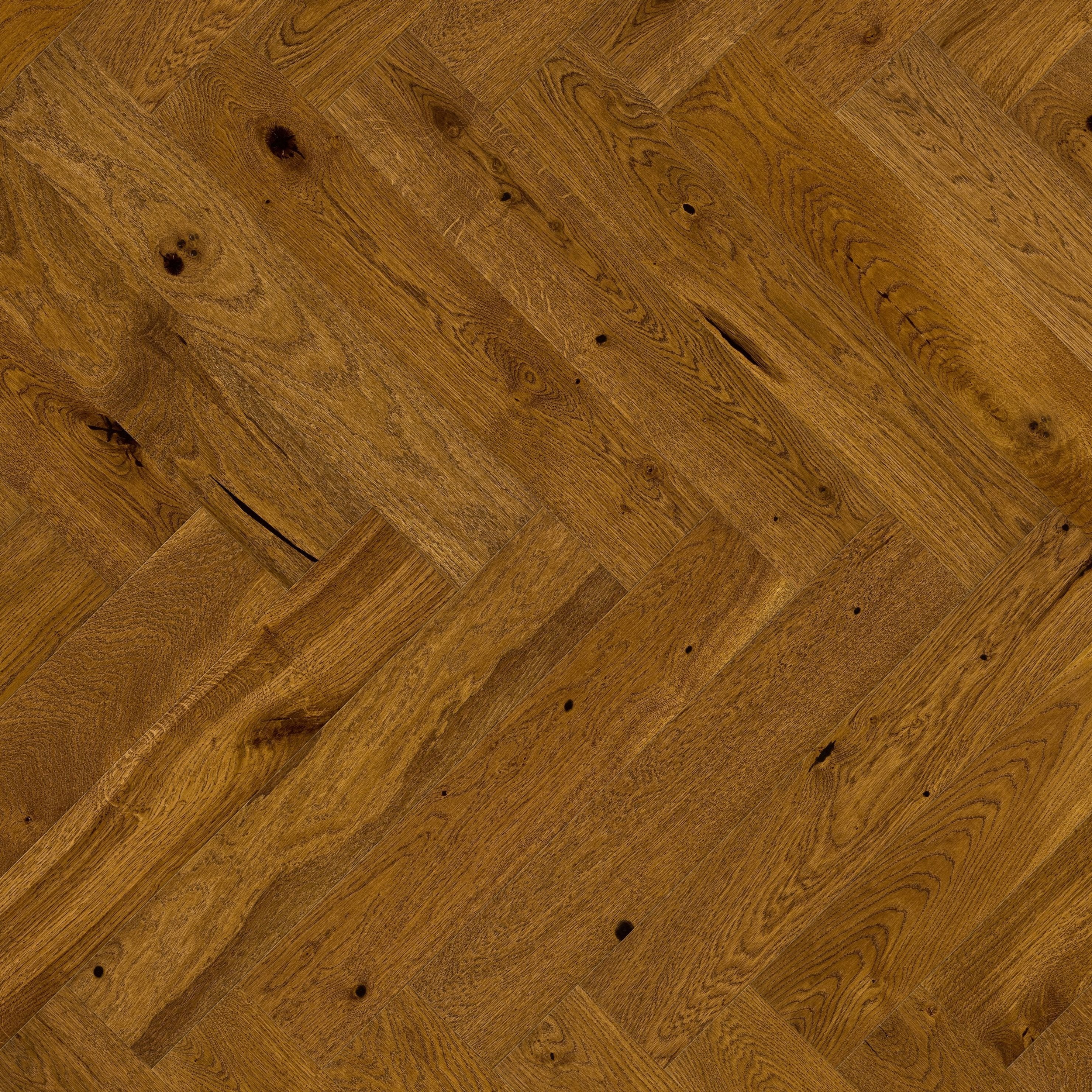 Brown wood flooring laid in herringbone pattern