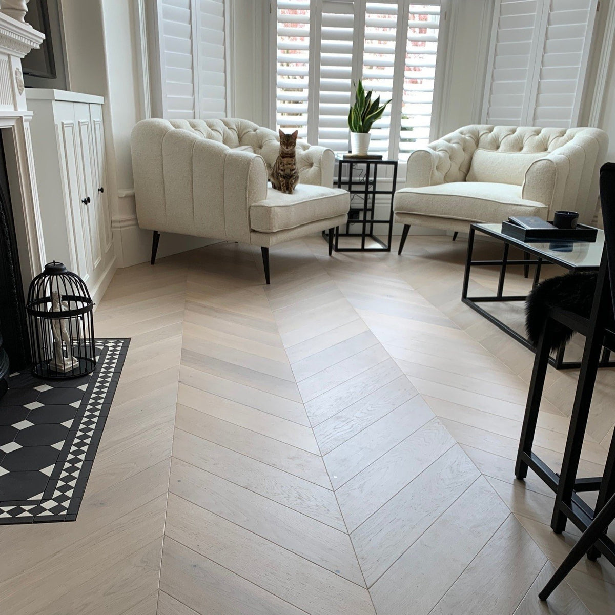 Luxury light wood flooring laid in chevron pattern